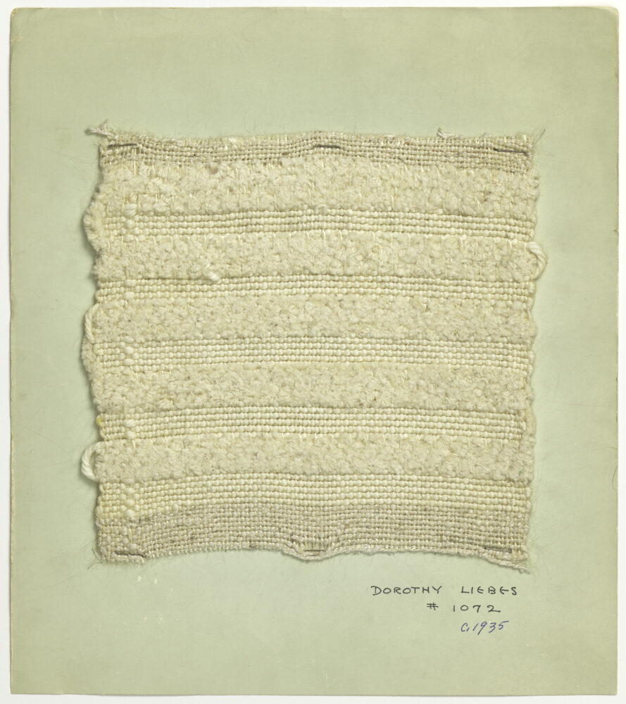 woven textile sample of cream thread on a mint board
