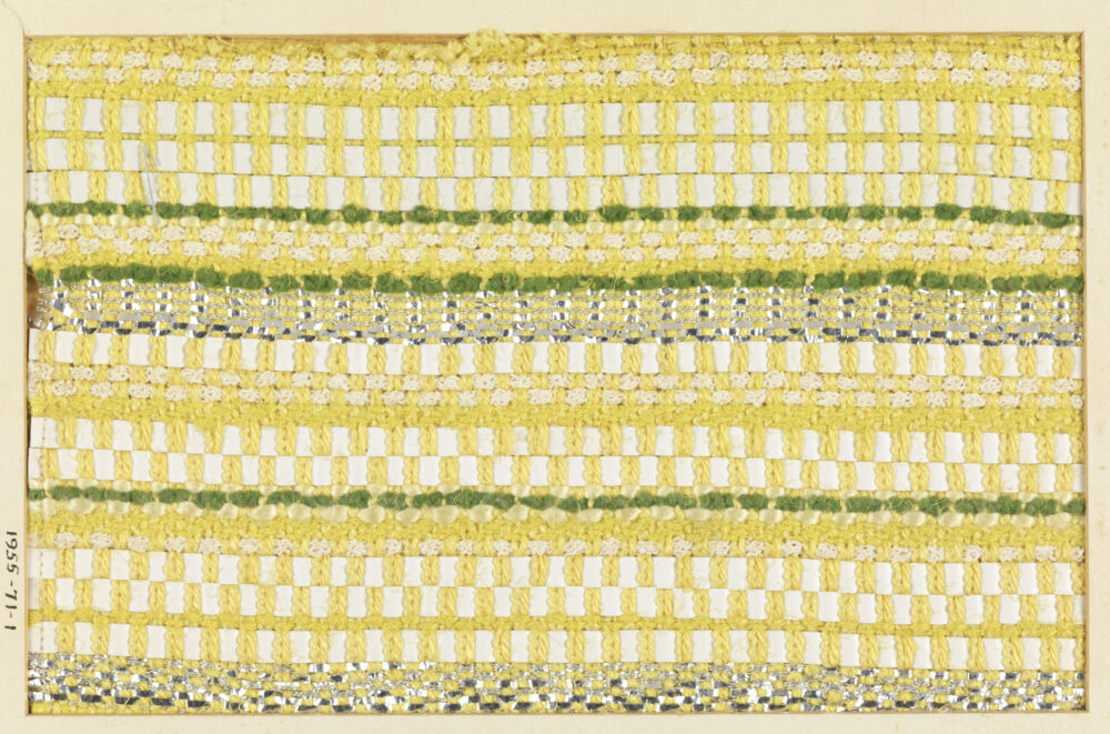 woven textile sample of yellow, green, and white threads mounted onto a white board