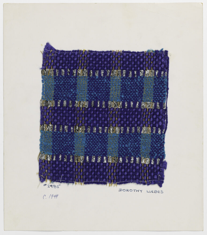 woven textile sample of blue and gold thread in a plaid pattern mounted onto a white board