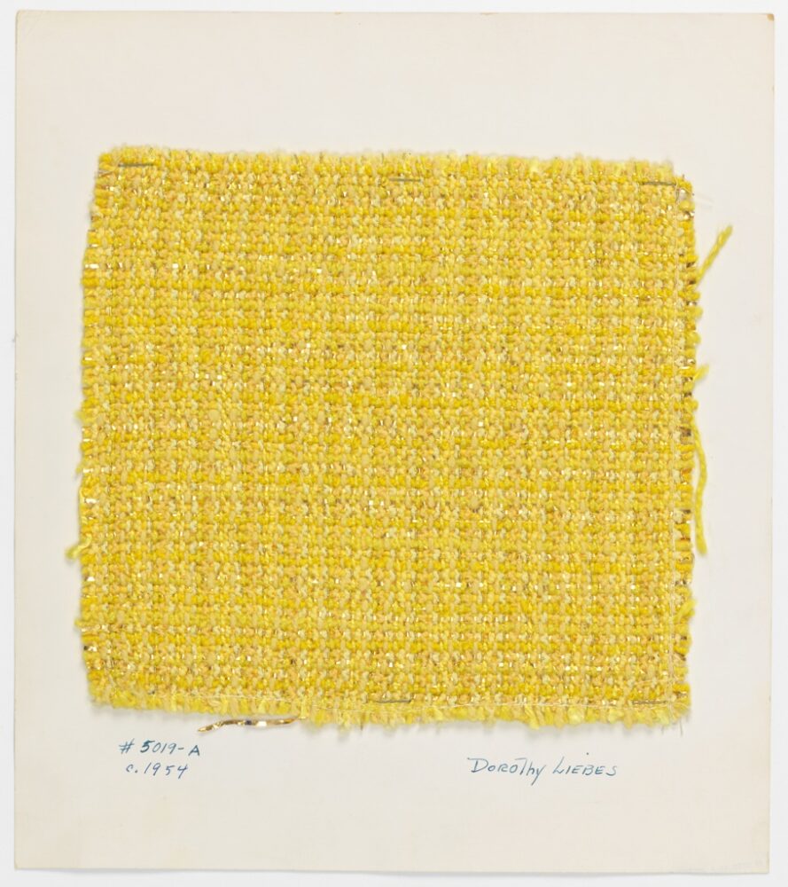woven textile sample of yellow and gold threads mounted onto a white board