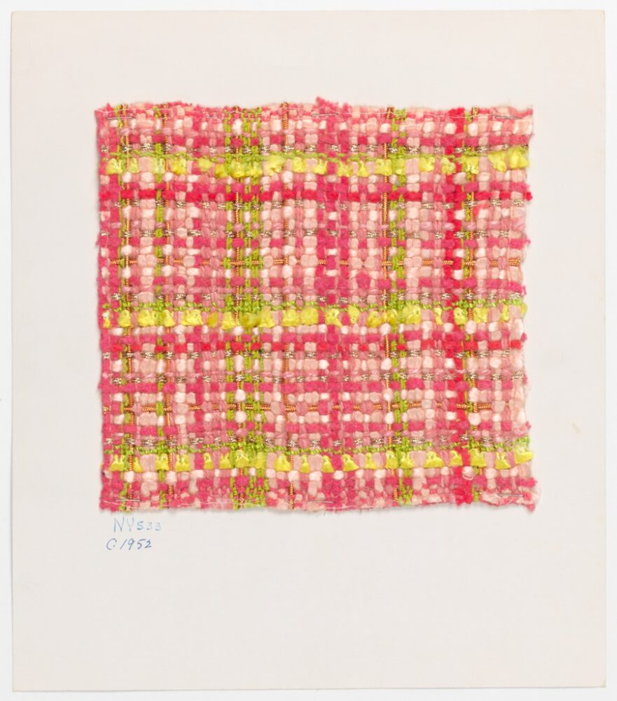 green, pink, and gold metallic threads are woven into a plaid sample and mounted onto a white board