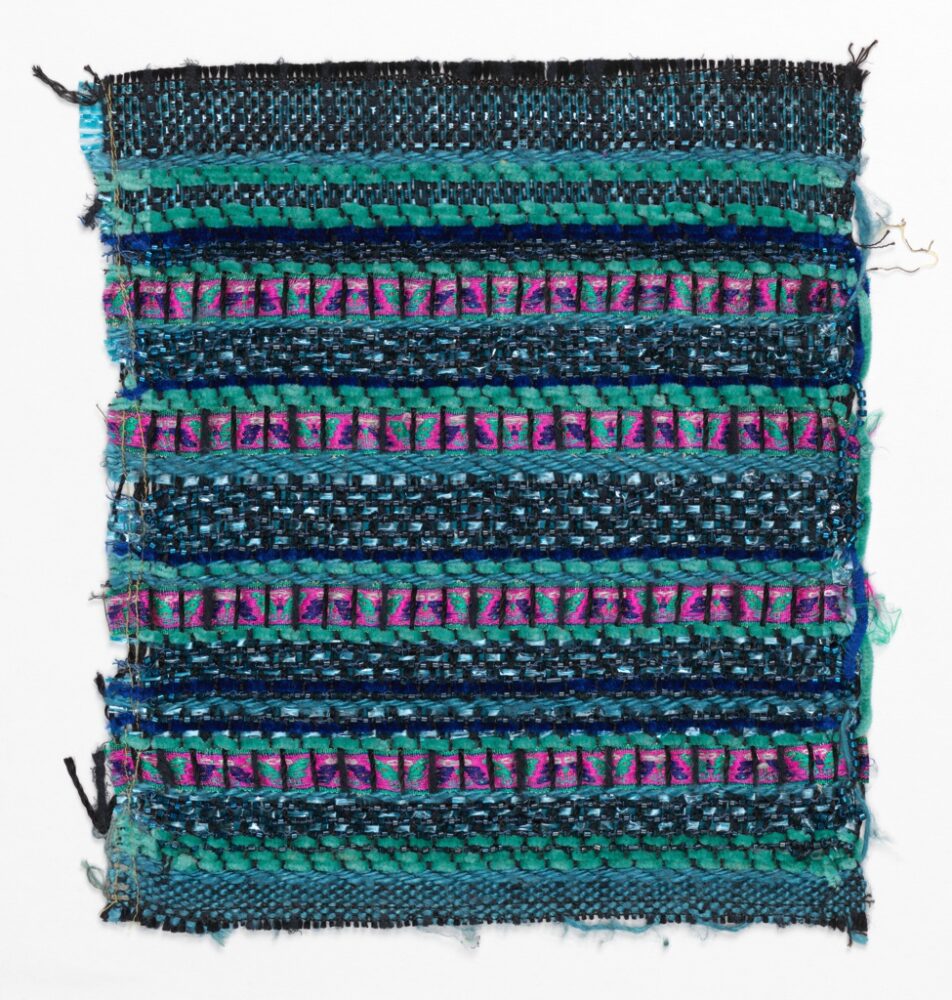 woven textile sample comprised of teal and black yarns and magenta ribbons