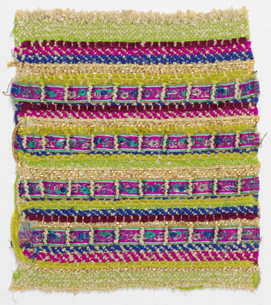 woven textile sample comprised of green, blue, and magenta threads with magenta ribbon