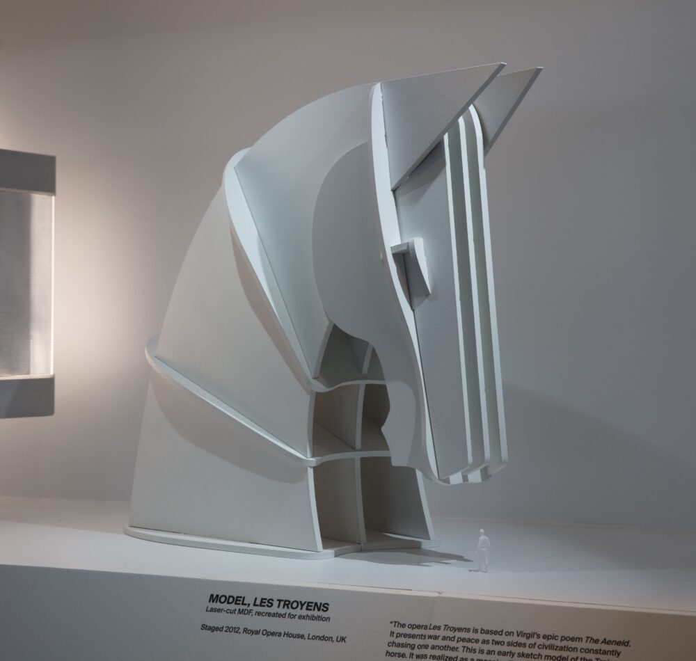 Installation view of a white model of a geometric horse head, facing right.