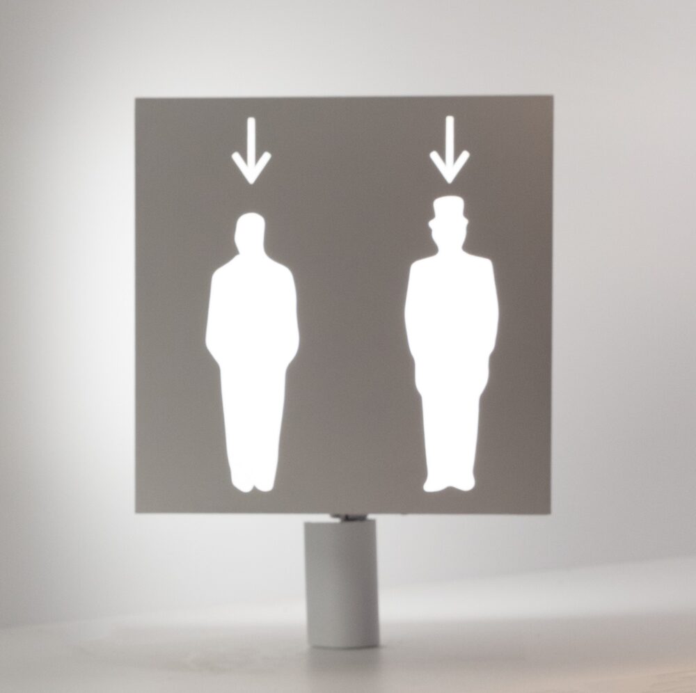A side of a cubic white model, glowing with white light from within, with two silhouette cutouts and an arrow pointing down at each figure.