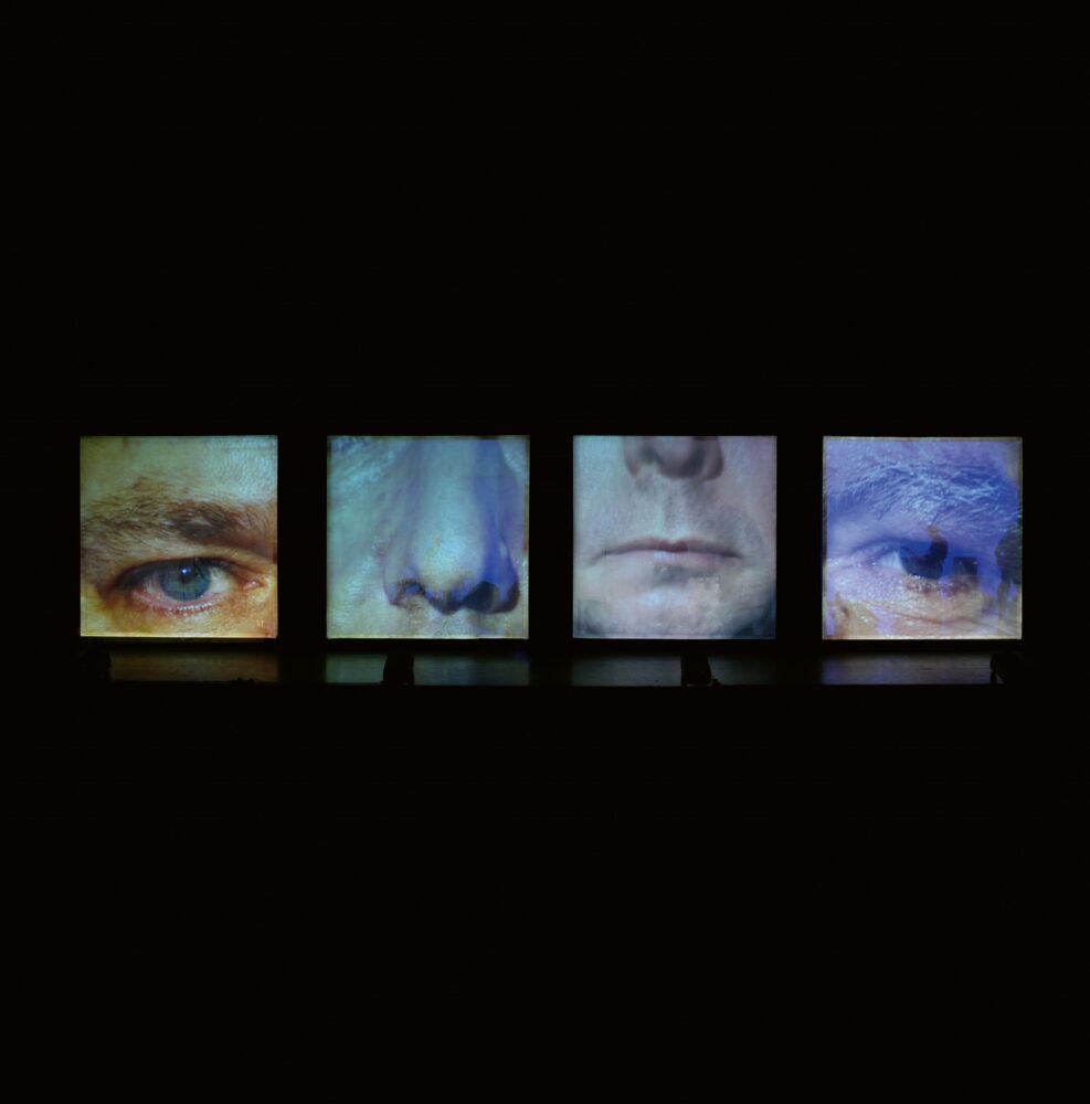Row of four cubes, the front face of each filled with cropped images of an eye, nose, mouth, and eye