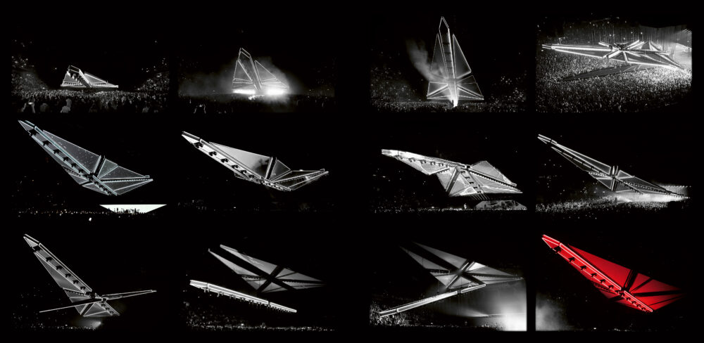 Series of twelve images showing, at different angles, the progression of a large triangular object transforming as it floats above a crowd; the images are black and white except the last one which shows the object in red.