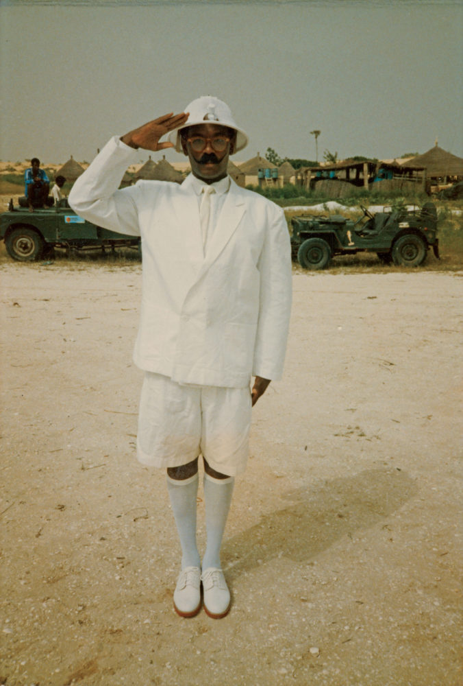 Photograph of Willi Smith dressed as a character from Expedition film wearing a white helmet and all-white ensemble