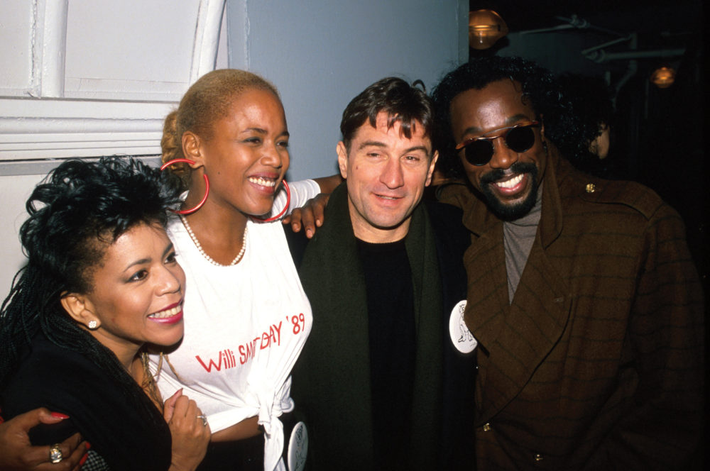 A group of four men and women pose together at an event celebrating Willi Smith Day 1989