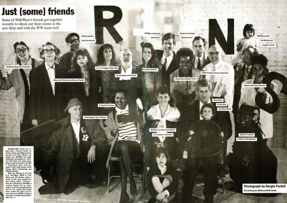 Grayscale image of a group of people posing for a photograph and holding giant letters spelling out “FRIENDS”