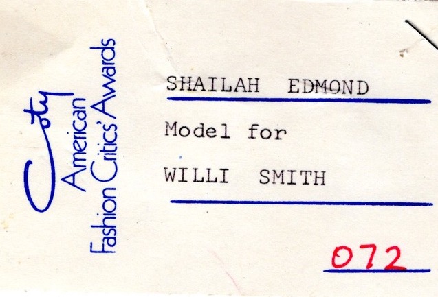 Paper tag that reads, "Coty American Fashion Critics' Awards," "Shailah Edmonds, Model for Willi Smith, 072."