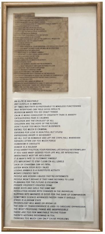 Cutout pieces of paper in a wooden frame listing various Truisms by Jenny Holzer